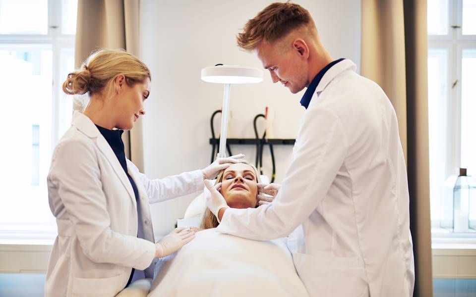 Clinician placing sensors on a patient’s head during a treatment session