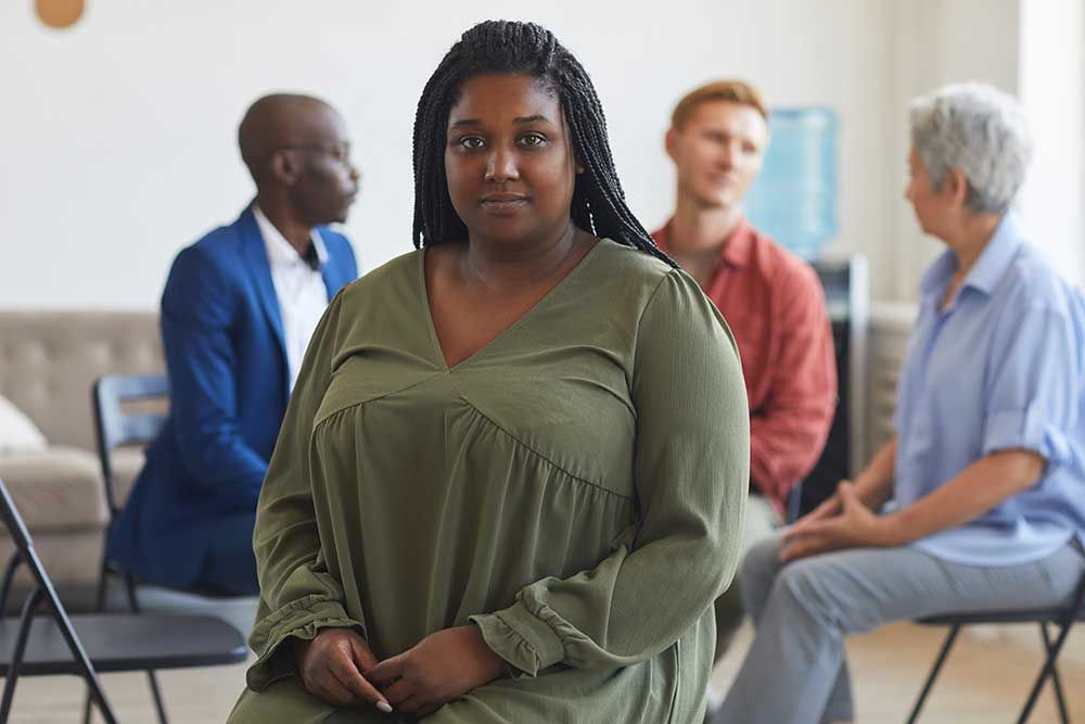 Client stepping forward during a group counseling session at Family Trauma Treatment Center